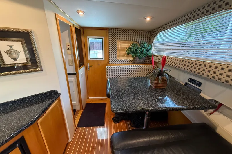 Slide: The Image of Interior of 1999 Blackfin 33 Flybridge yacht with elegant dining area and modern decor. - 39
