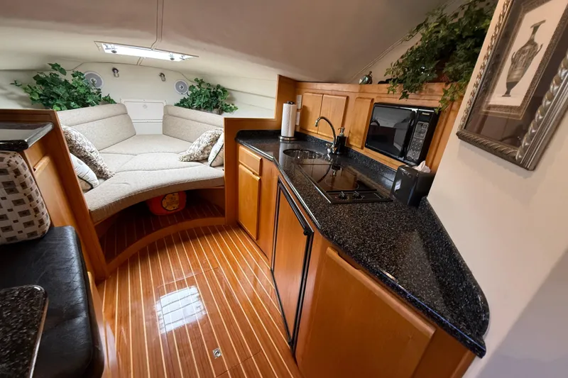 Slide: The Image of Interior of 1999 Blackfin 33 Flybridge with cozy seating and modern kitchenette. - 34