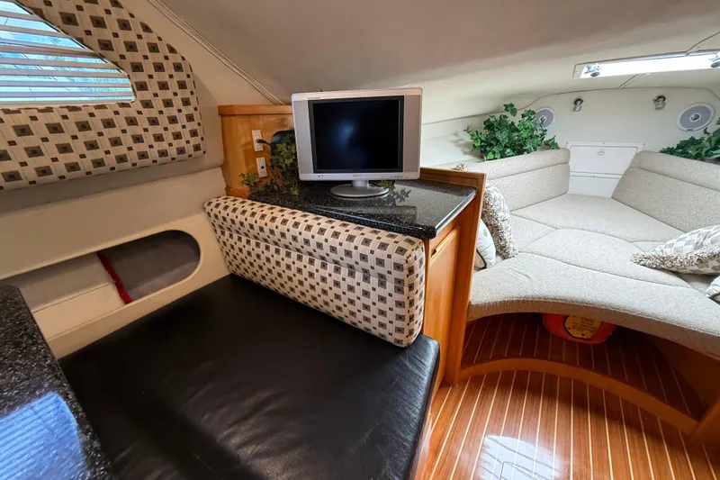 Slide: The Image of Interior of 1999 Blackfin 33 Flybridge with cozy seating and TV. - 46