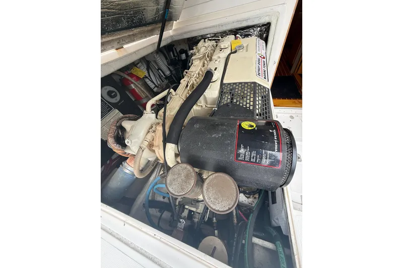 Slide: The Image of Engine compartment of a 1999 Blackfin 33 Flybridge boat, showcasing mechanical components. - 63