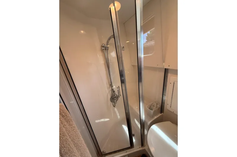 Slide: The Image of Shower area in 1999 Blackfin 33 Flybridge boat, featuring sleek glass door and modern fixtures. - 53