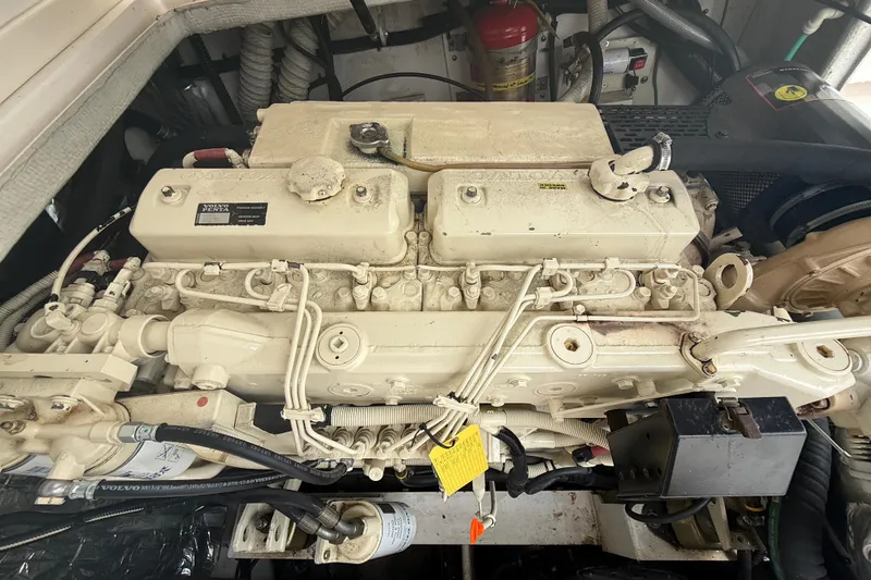 Slide: The Image of Engine compartment of a 1999 Blackfin 33 Flybridge boat, featuring a Volvo Penta engine. - 65