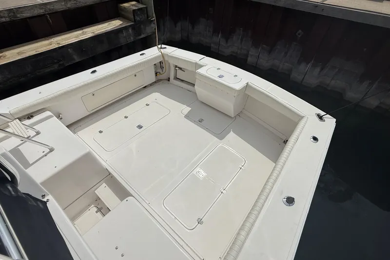 Slide: The Image of 1999 Blackfin 33 Flybridge boat deck with storage compartments, docked at marina. - 15