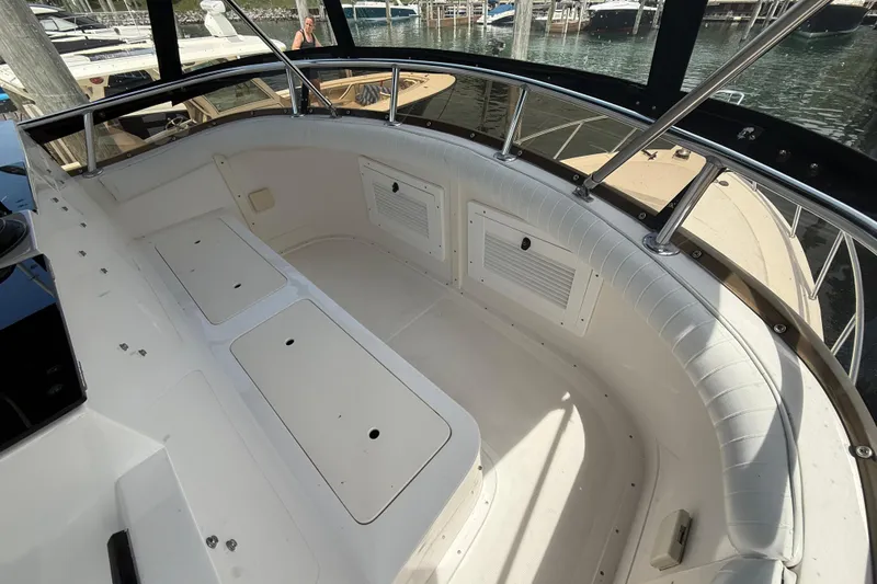 Slide: The Image of 1999 Blackfin 33 Flybridge boat interior with cushioned seating and storage compartments. - 25