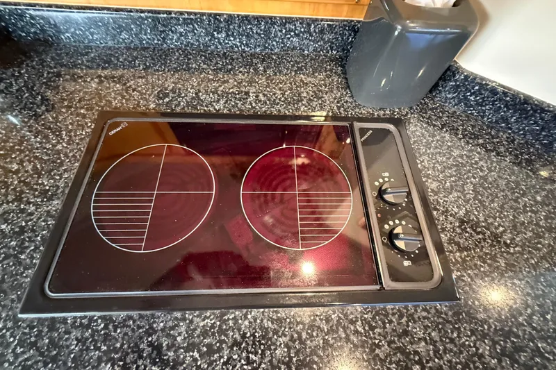 Slide: The Image of Ceramic cooktop on Blackfin 33 Flybridge 1999, featuring dual burners and sleek black countertop. - 45