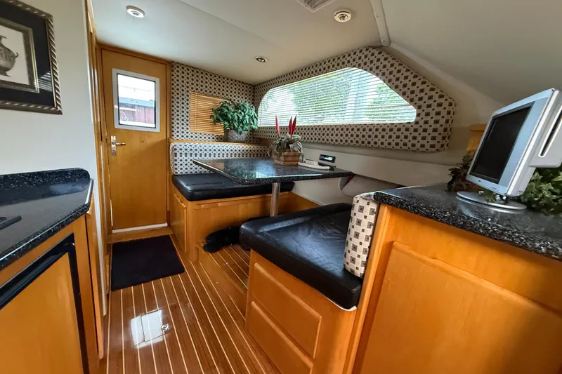 Slide: The Image of Interior of 1999 Blackfin 33 Flybridge with wood accents and seating area. - 38