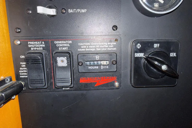 Slide: The Image of Control panel of a 1999 Blackfin 33 Flybridge boat with generator switches. - 59