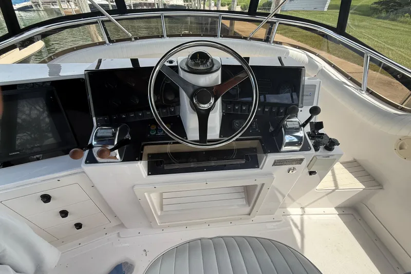 Slide: The Image of Cockpit of 1999 Blackfin 33 Flybridge boat with steering wheel and control panel. - 24