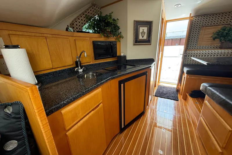 Slide: The Image of Luxurious interior of 1999 Blackfin 33 Flybridge yacht with modern kitchen amenities. - 42