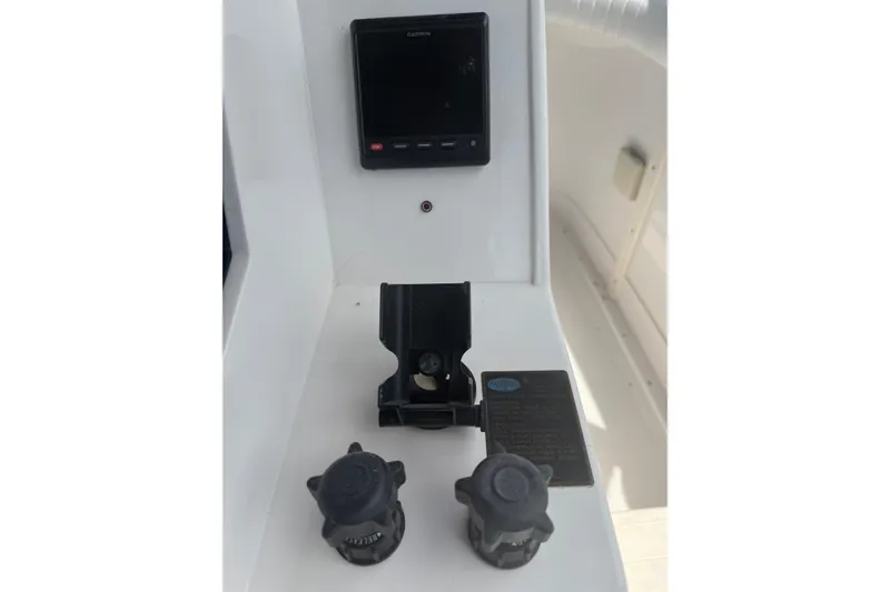 Slide: The Image of 1999 Blackfin 33 Flybridge dashboard with Garmin display and control knobs. - 28