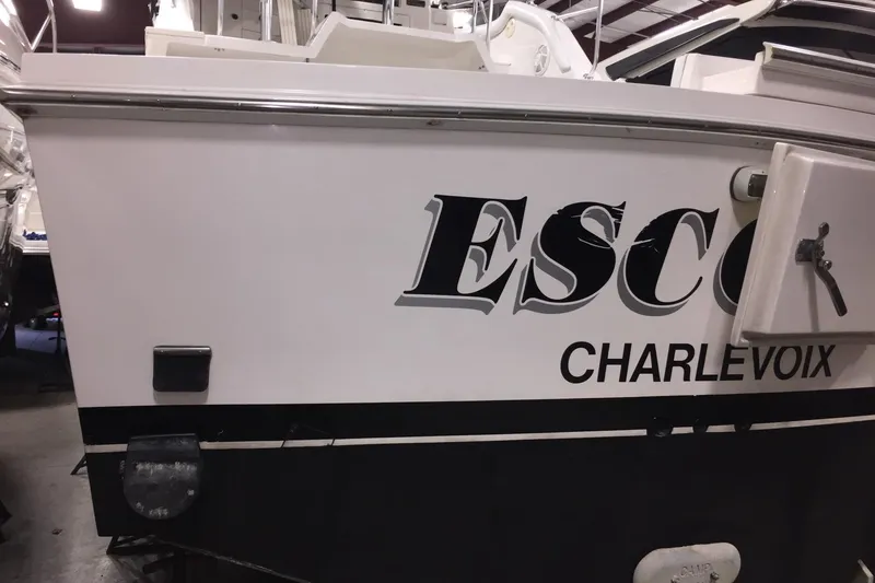 Slide: The Image of 1999 Blackfin 33 Flybridge boat with "ESCO" and "CHARLEVOIX" text on the side. - 56