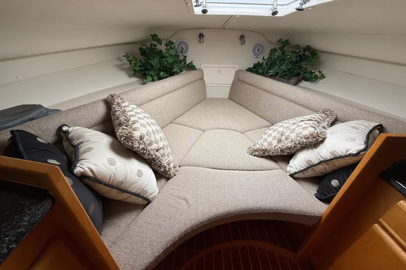 Slide: The Image of Cozy interior of 1999 Blackfin 33 Flybridge with plush seating and decorative pillows. - 49