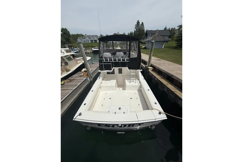 Slide: The Image of 1999 Blackfin 33 Flybridge boat docked at marina, featuring spacious deck and flybridge. - 13