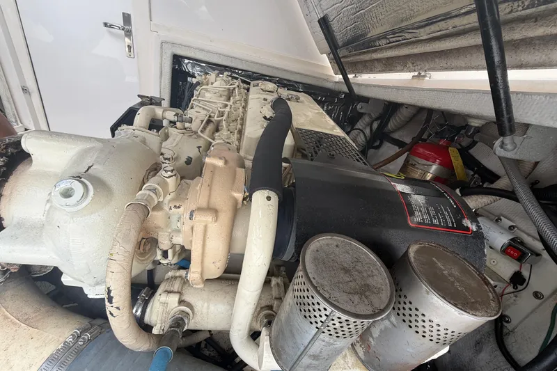 Slide: The Image of Engine compartment of a 1999 Blackfin 33 Flybridge boat, showcasing mechanical components. - 66