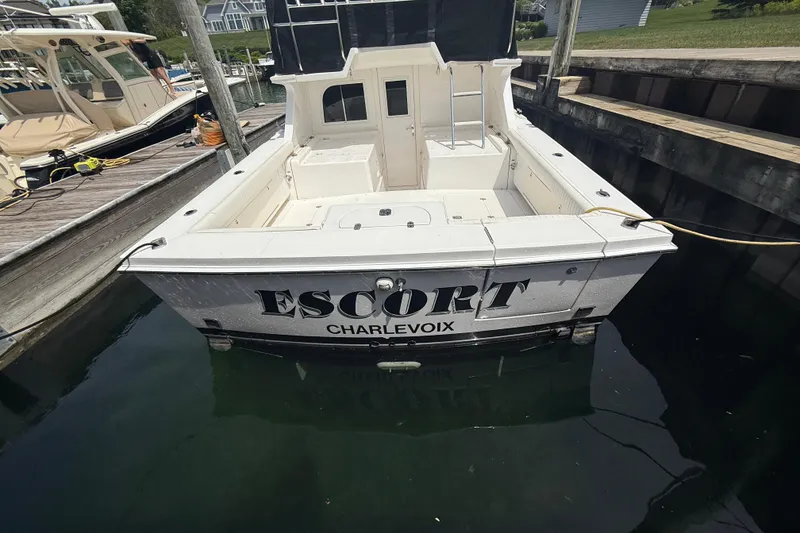Slide: The Image of 1999 Blackfin 33 Flybridge boat named "Escort" docked in Charlevoix marina. - 14