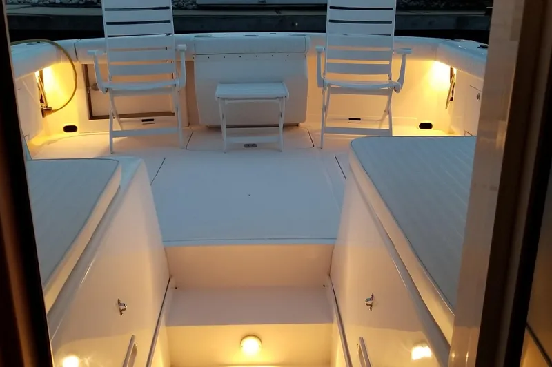 Slide: The Image of 1999 Blackfin 33 Flybridge boat interior with ambient lighting and seating arrangement. - 68