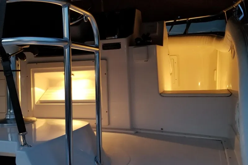 Slide: The Image of Interior view of a 1999 Blackfin 33 Flybridge boat with illuminated compartments. - 69