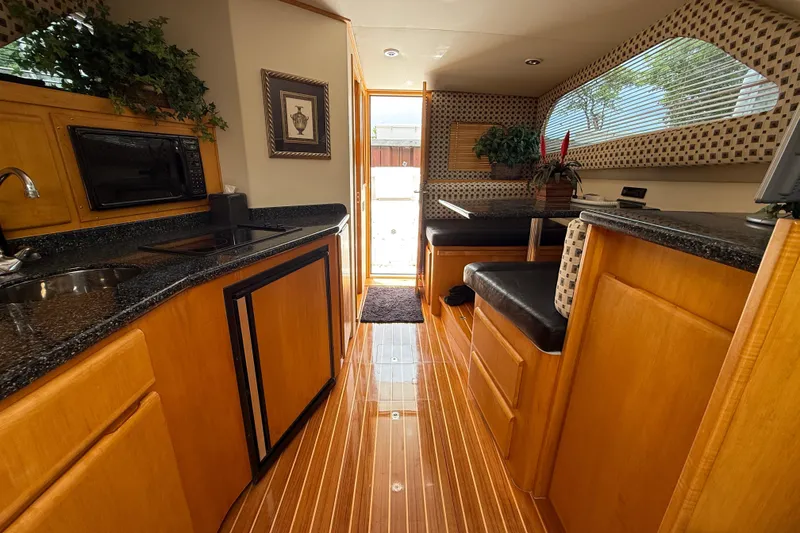 Slide: The Image of Interior of a 1999 Blackfin 33 Flybridge yacht with wood cabinetry and modern amenities. - 36