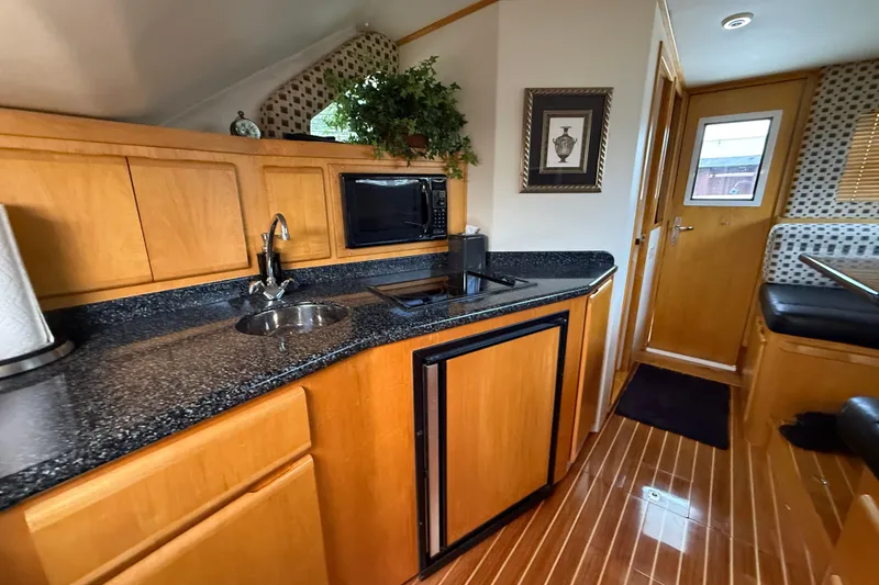 Slide: The Image of Interior of 1999 Blackfin 33 Flybridge yacht with modern kitchen and wood accents. - 43