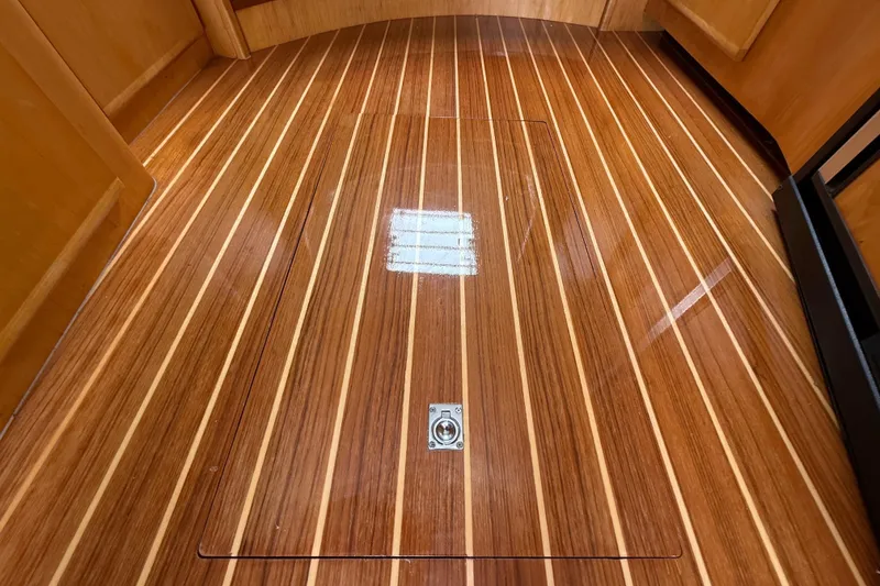 Slide: The Image of Polished wooden floor of 1999 Blackfin 33 Flybridge boat interior. - 54