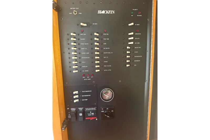 Slide: The Image of Control panel of a 1999 Blackfin 33 Flybridge boat with various switches and indicators. - 60