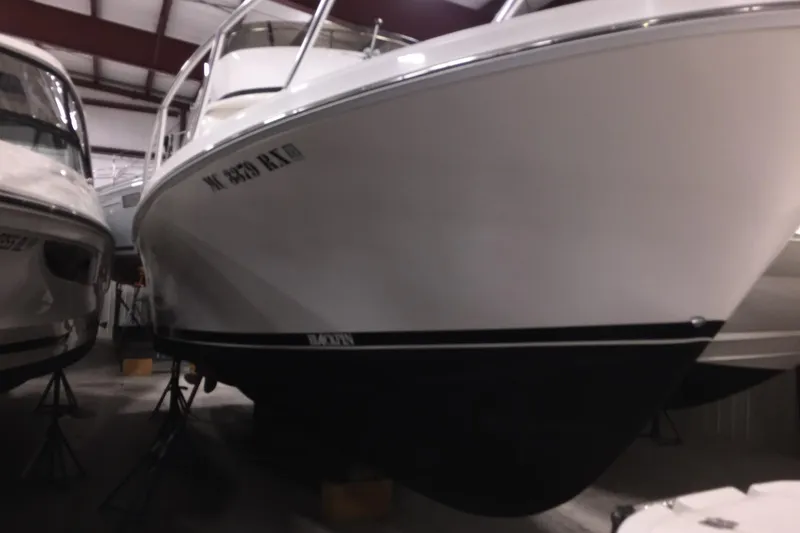 Slide: The Image of 1999 Blackfin 33 Flybridge boat in storage, viewed from the front. - 58