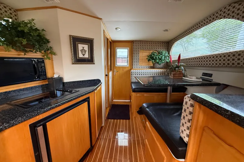 Slide: The Image of Interior of 1999 Blackfin 33 Flybridge yacht with modern kitchen and seating area. - 35