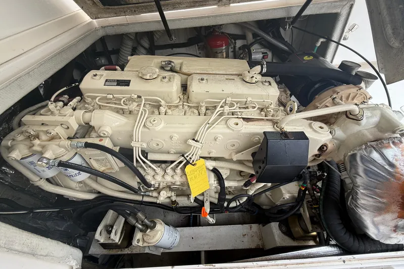 Slide: The Image of Engine compartment of a 1999 Blackfin 33 Flybridge boat, showcasing detailed machinery. - 64