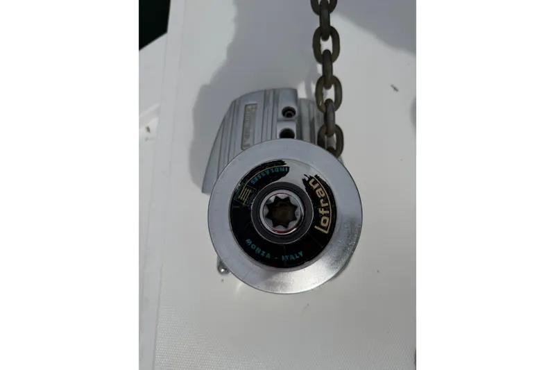 Slide: The Image of Lofrans windlass on 1999 Blackfin 33 Flybridge boat, featuring a metal chain. - 21
