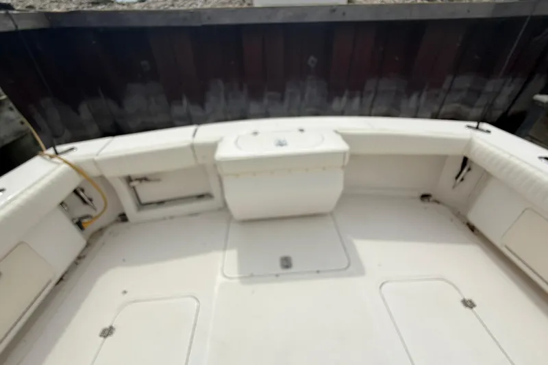 Slide: The Image of 1999 Blackfin 33 Flybridge boat deck with seating and storage compartments. - 17