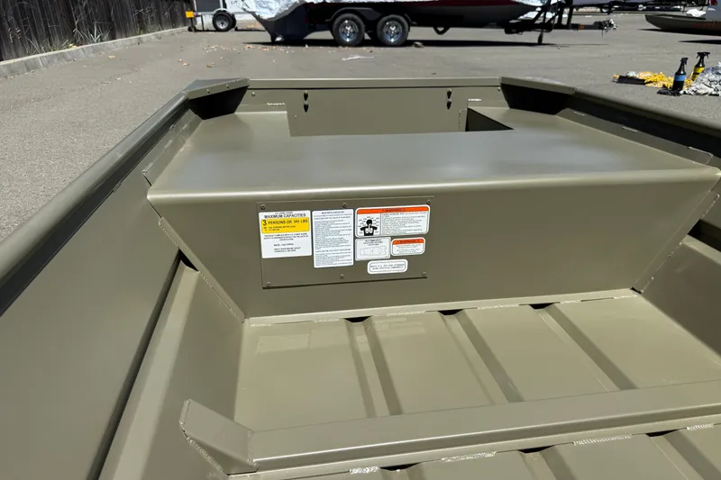 Slide: The Image of 2026 Tracker Grizzly 14 Jon boat interior with capacity labels in a parking lot. - 8