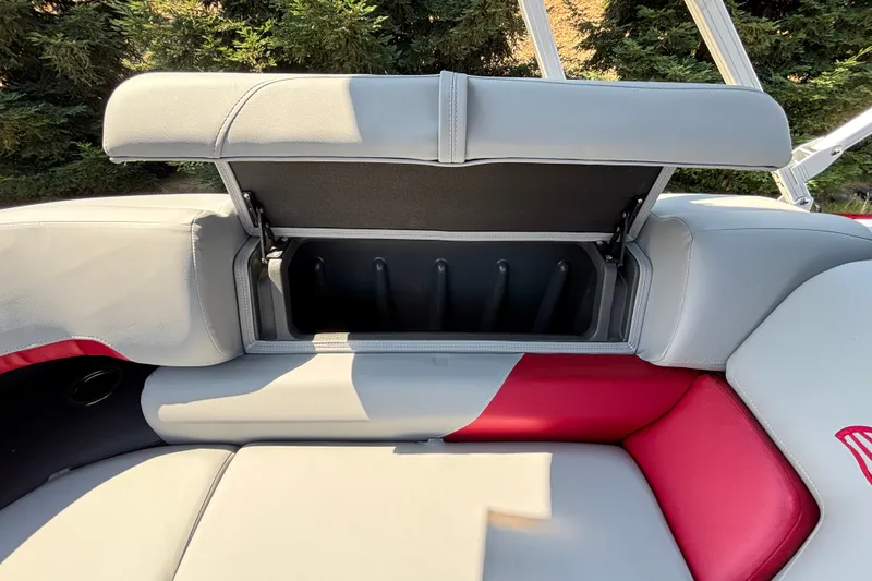 Slide: The Image of Sun Tracker Party Barge 22 XP3, 2026 model, open storage compartment on boat seat. - 18