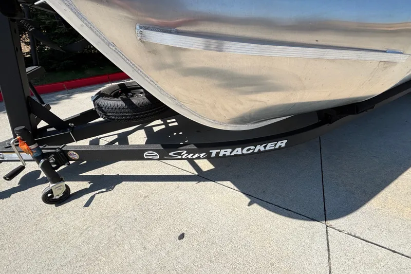 Slide: The Image of 2026 Sun Tracker Party Barge 22 XP3 trailer, close-up view on pavement. - 51