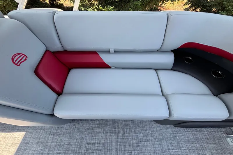 Slide: The Image of Luxurious seating on 2026 Sun Tracker Party Barge 22 XP3 with red accents and cup holders. - 28