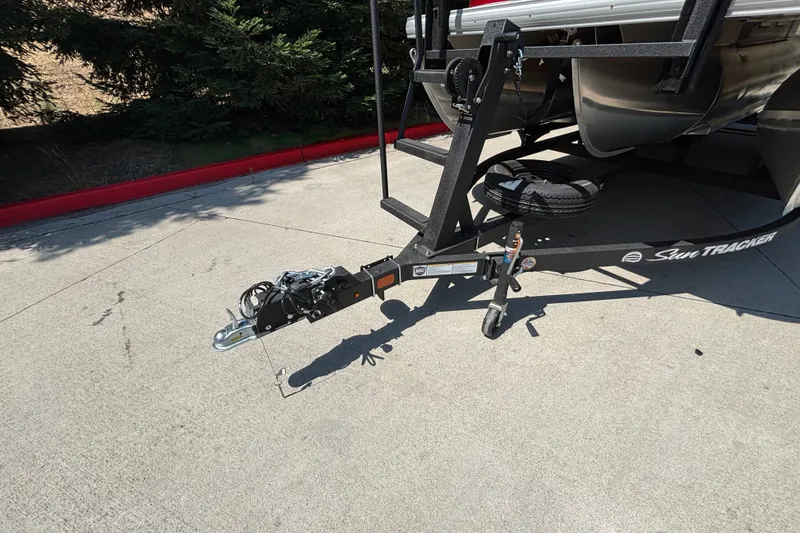 Slide: The Image of 2026 Sun Tracker Party Barge 22 XP3 trailer hitch on concrete driveway. - 48