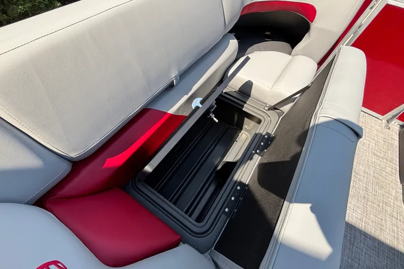 Slide: The Image of 2026 Sun Tracker Party Barge 22 XP3 with open storage compartment, red and gray seating. - 14