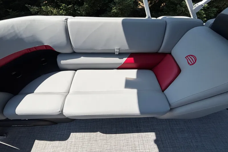 Slide: The Image of 2026 Sun Tracker Party Barge 22 XP3 boat seating with gray and red upholstery. - 33