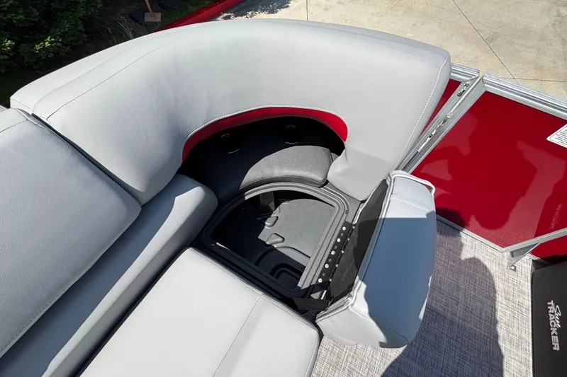 Slide: The Image of Sun Tracker Party Barge 22 XP3 2026, featuring open storage compartment and cushioned seating. - 21