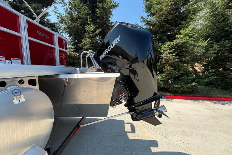 Slide: The Image of 2026 Sun Tracker Party Barge 22 XP3 with Mercury outboard motor, parked outdoors. - 47