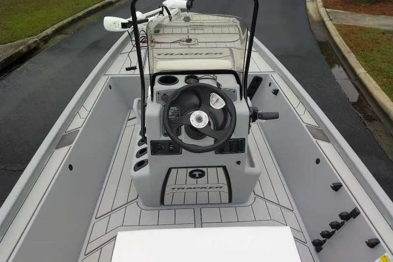Slide: The Image of 2026 Tracker Bass Tracker Classic CC boat interior with steering console and seating. - 6