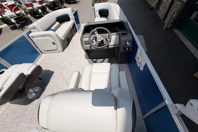 Slide: The Image of 2026 Sun Tracker Party Barge 22 RF DLX interior with plush seating and modern helm. - 2