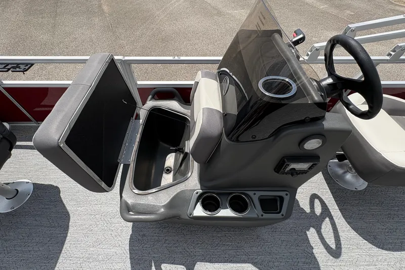 Slide: The Image of The image shows the cockpit of a Sun Tracker Bass Buggy 18 DLX with steering wheel and instruments. - 14