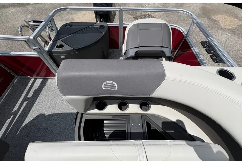 Slide: The Image of The image shows the cockpit of a Sun Tracker Bass Buggy 18 DLX with gray and white seating. - 16