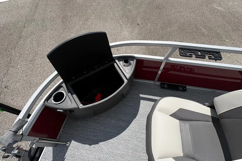 Slide: The Image of Partial view of a boat with gray and white seat, red dashboard, and cup holder. - 13
