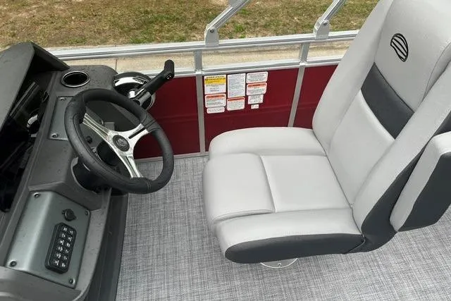 Slide: The Image of 2026 Sun Tracker SportFish 20 DLX boat interior with steering wheel and captain's chair. - 5