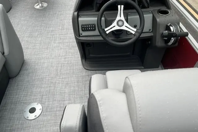 Slide: The Image of Interior view of 2026 Sun Tracker SportFish 20 DLX boat, featuring steering wheel and seating. - 8