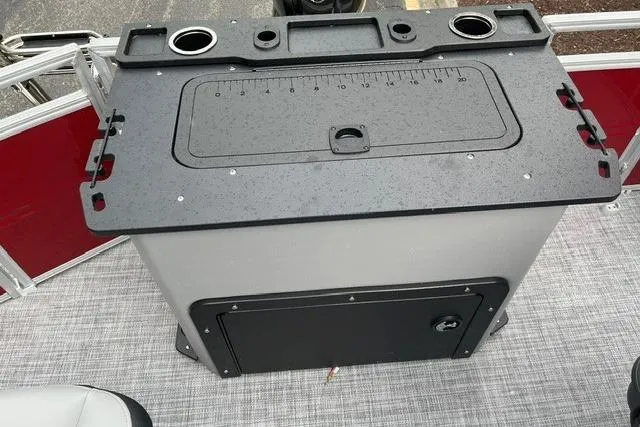 Slide: The Image of 2026 Sun Tracker SportFish 20 DLX fishing station with cup holders and storage compartment. - 7