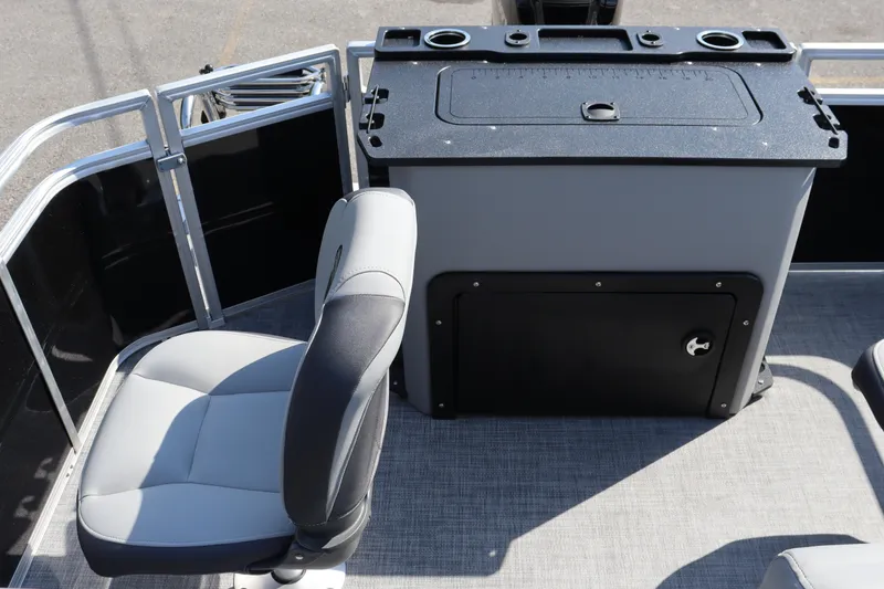 Slide: The Image of 2026 Sun Tracker SportFish 20 DLX boat interior with seating and storage compartment. - 12