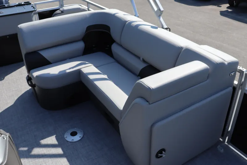 Slide: The Image of Luxurious seating on 2026 Sun Tracker SportFish 20 DLX pontoon boat, featuring plush gray upholstery. - 8
