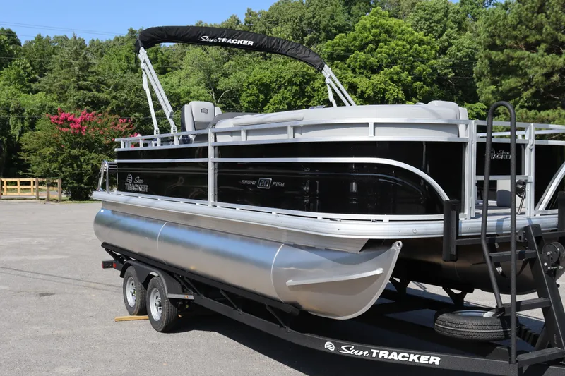 Slide: The Image of 2026 Sun Tracker SportFish 20 DLX pontoon boat on trailer, parked outdoors. - 15